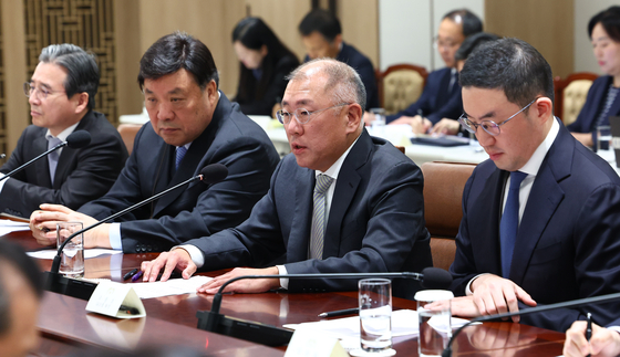 From left, presidential policy chief Kim Yong-beom, Celltrion Chairman Seo Jung-jin, Hyundai Motor Group Executive Chair Euisun Chung and LG Group Chairman Koo Kwang-mo speak during a follow-up meeting on the recently concluded tariff negotiations with the United States at the Yongsan presidential office in central Seoul on Nov. 16. [YONHAP] 