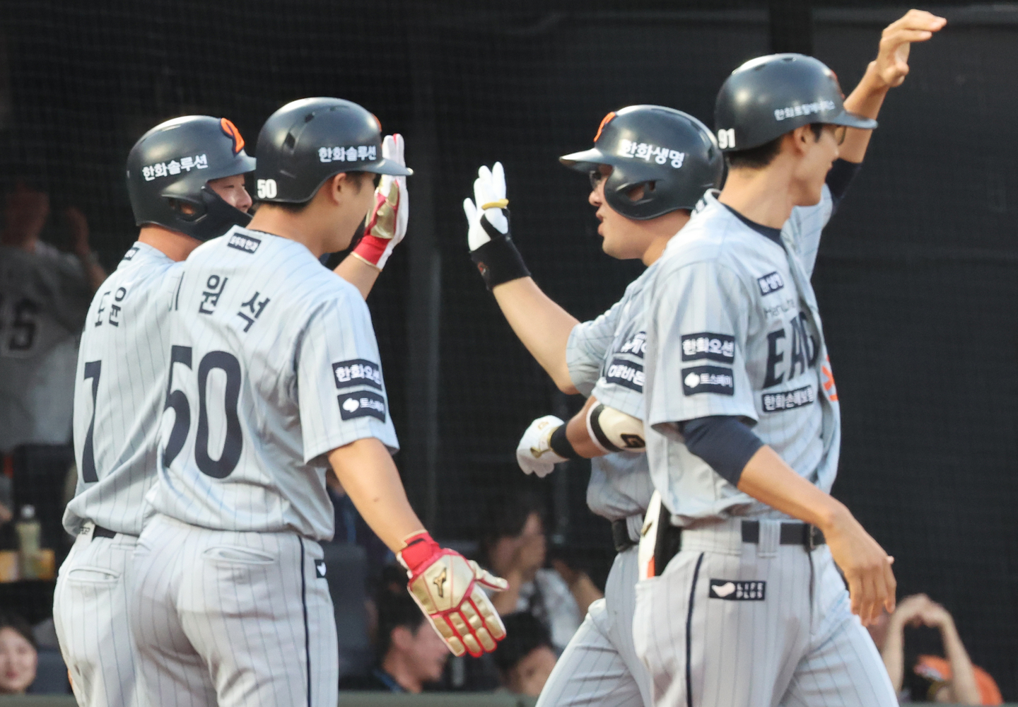 Hanwha Eagles infielder An Chi-hong, second from right, high-fives his teammates after hitting a home run during a game against the Lotte Giants at Sajik Stadium in Busan on June 17. [YONHAP]