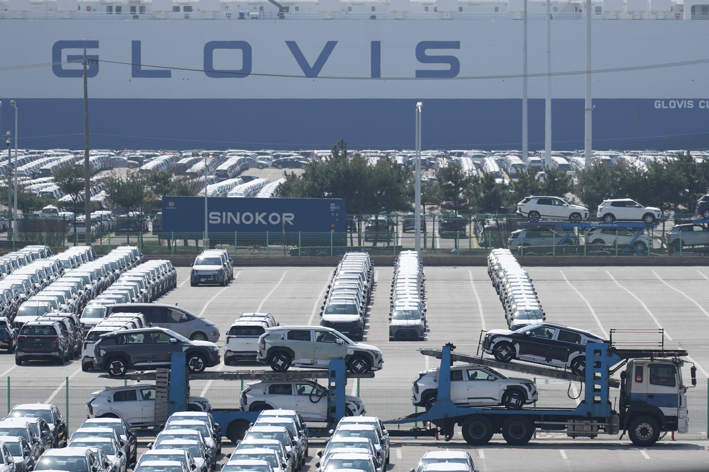 New cars for export on a car carrier trailer arrive at a port in Pyeongtaek in Gyeonggi on April 15. [AP/YONHAP]