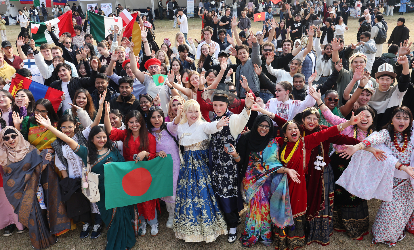 Foreign students in traditional dress gather for a photo during the “Ajou International Day” event at Ajou University in Suwon, Gyeonggi, on Nov. 6.  [YONHAP] 