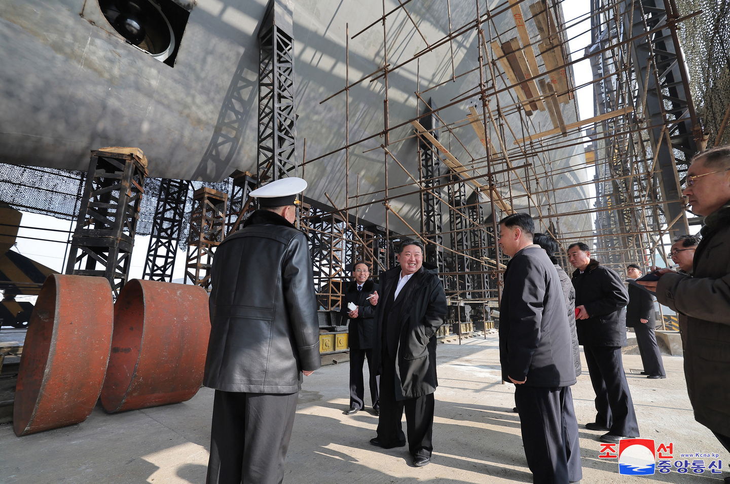 This photo, carried by North Korea's official Korean Central News Agency on March 8, shows leader Kim Jong-un visiting a major shipyard to inspect the progress of building a nuclear-propelled submarine. [KCNA]