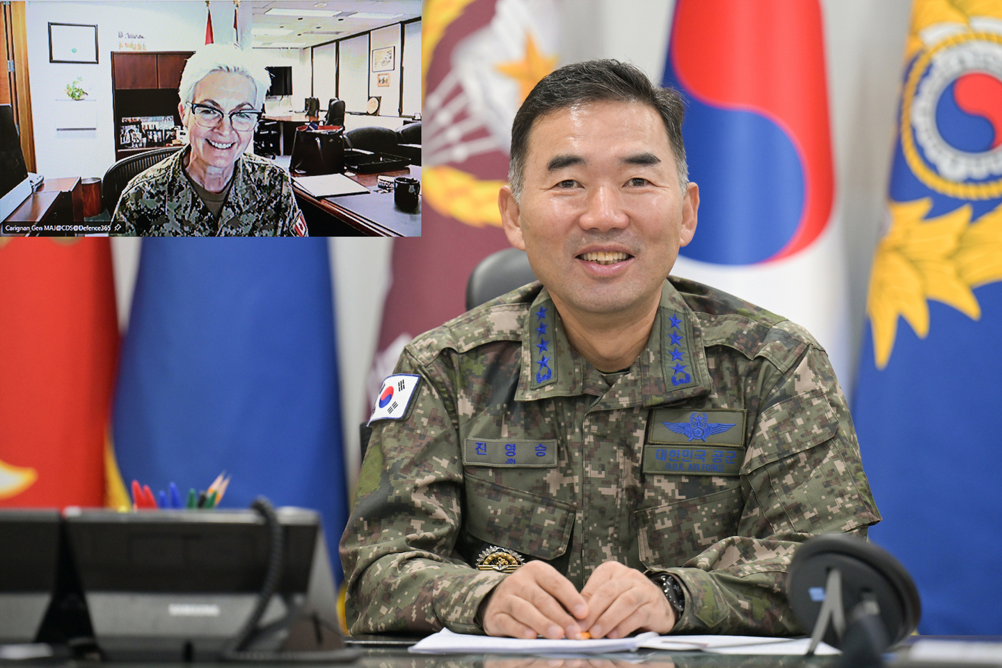 Joint Chiefs of Staff (JCS) Chairman Gen. Jin Yong-sung, center, holds his first phone call with his Canadian counterpart, Gen. Jennie Carignan, to discuss expanding defense cooperation between the countries in this photo provided by the JCS on Nov. 28. [YONHAP] 