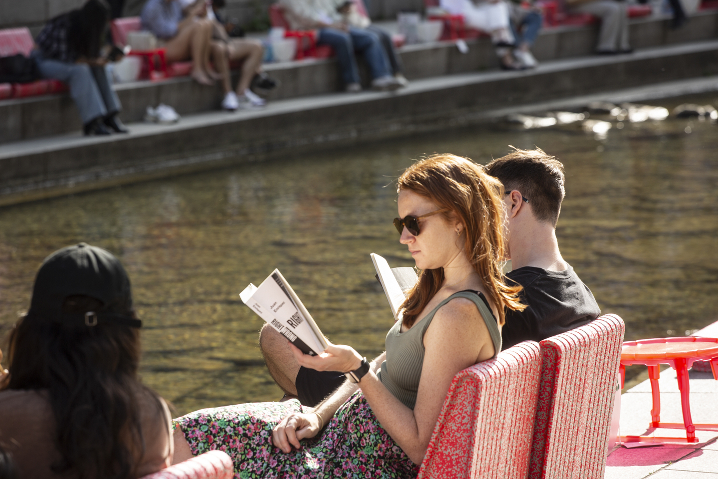 Visitors read books at an outdoor library along Cheonggyecheon in central Seoul in an undated photo provided by the Seoul city government. [SEOUL METROPOLITAN GOVERNMENT]