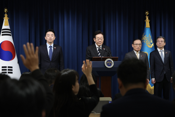 President Lee Jae Myung, center, takes questions from reporters after an address at the presidential office in Yongsan District, central Seoul, on Dec. 3, marking the first anniversary of former President Yoon Suk Yeol's declaration of martial law. [JOINT PRESS CORPS] 