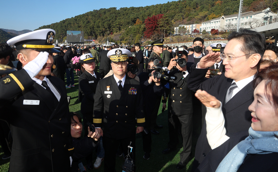 Samsung Electronics Chairman Lee Jae-yong and his mother Hong Ra-hee, right, and Lee Jee-ho, the chairman’s son, salute each other during a commissioning ceremony at the Korea Naval Academy in Changwon, South Gyeongsang, on Nov. 28. [YONHAP]