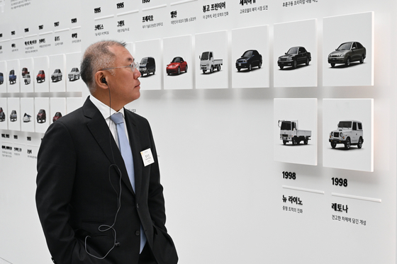 Hyundai Motor Group Executive Chair Euisun Chung tours an exhibition marking Kia's history at its 80th anniversary ceremony event in Yongin, Gyeonggi, on Dec. 5. [KIA] 