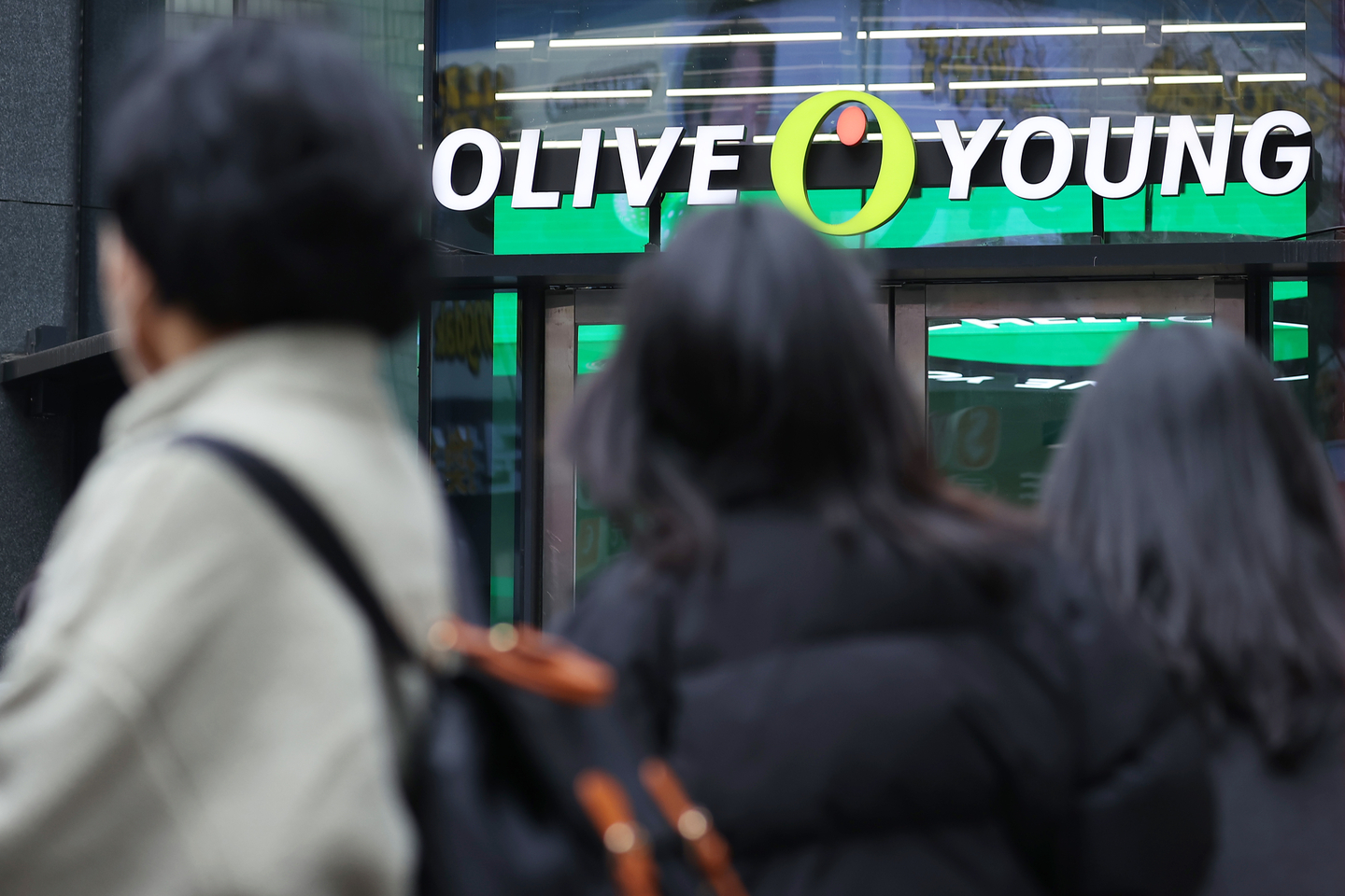 People are seen passing by an Olive Young store in Seoul on March 12. [YONHAP]