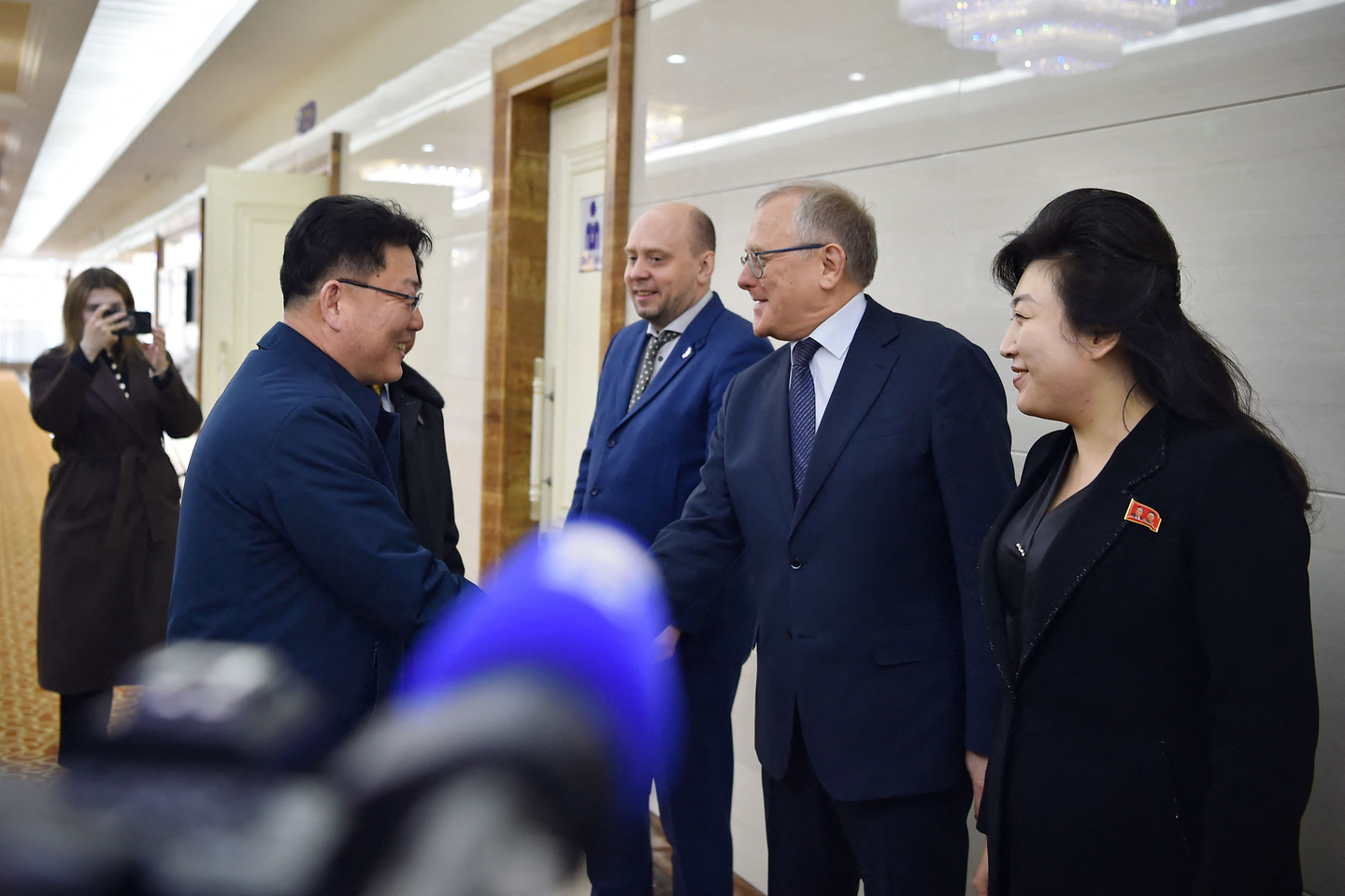 Yun Jong Ho, left, minister of External Economic Relations and North Korea's chairman to the inter-governmental committee, is given a send off before leaving for Russia, by Aleksandr Matsegora, second from right, Russia's Ambassador to North Korea, at Pyongyang International Airport in Pyongyang on March 17. [AFP/YONHAP]