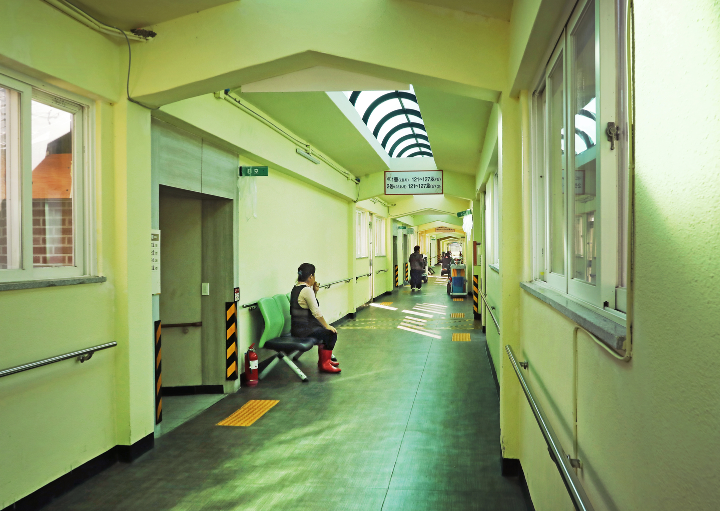 People sit and walk along a corridor at Sorokdo National Hospital in Goheung County, South Jeolla, on Nov. 6. [PARK SANG-MOON]