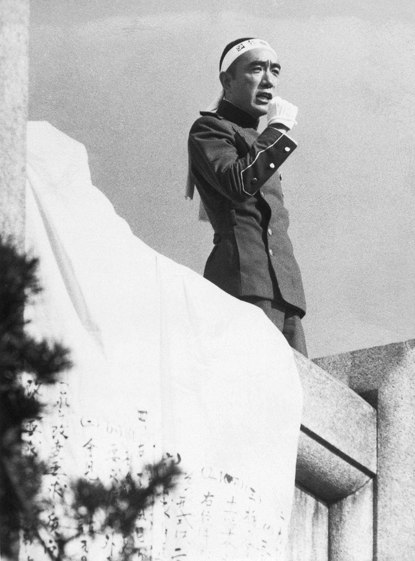 Japanese novelist Yukio Mishima delivers a speech on the balcony of the Japan Ground Self-Defense Force (JGSDF) building in Tokyo, before committing Harakiri suicide with a short sword. [WIKIPEDIA]