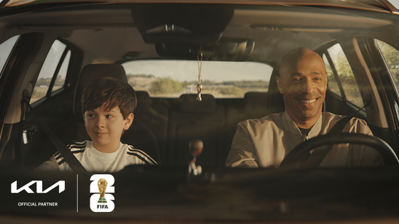 This image provided by Kia shows its global ambassador, Thierry Henry, right, starring in a teaser video as part of the company's global promotional campaign for the FIFA World Cup 2026. [KIA]