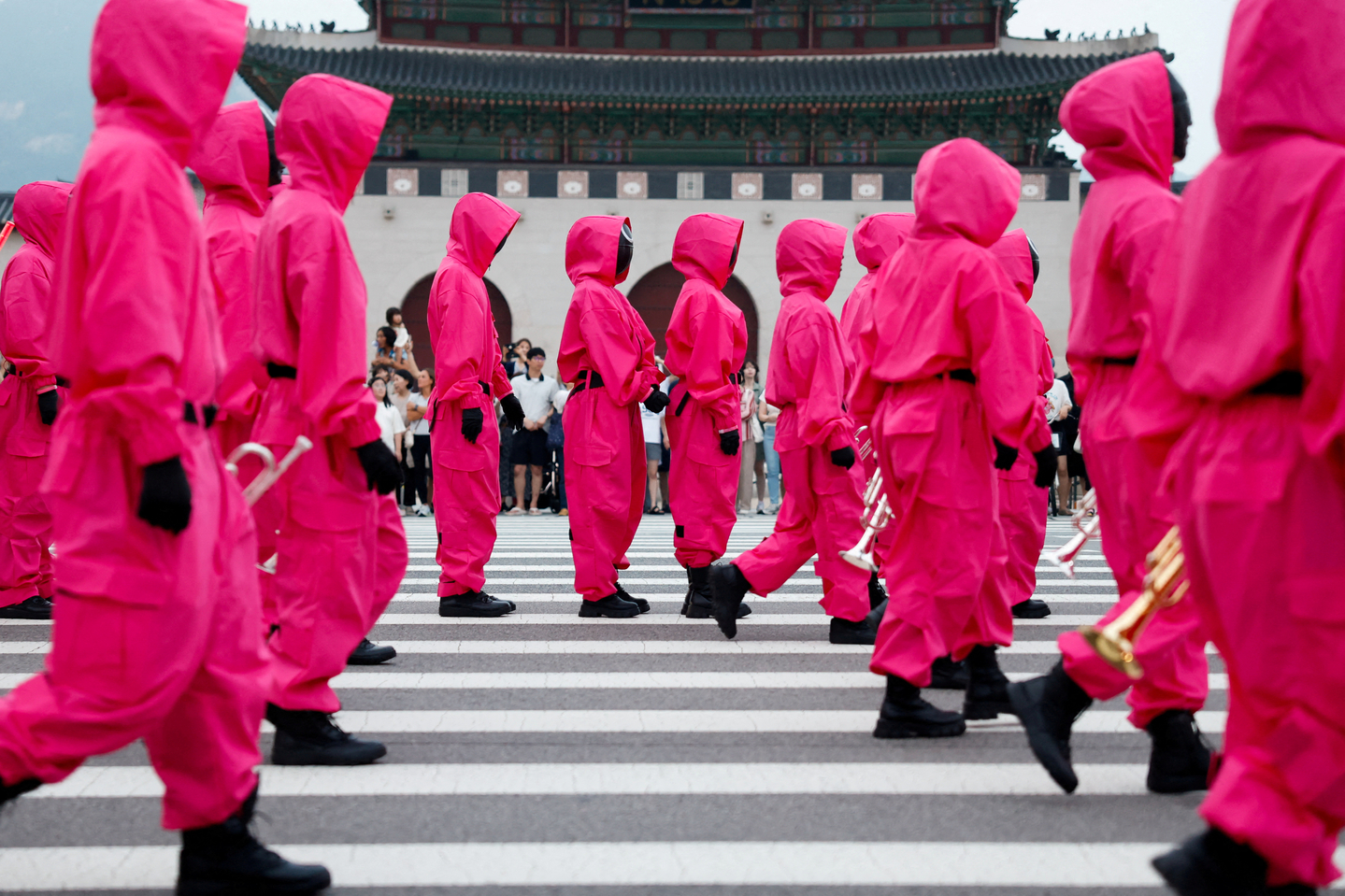 Performers dressed as ″Squid Game″ (2021-2025) soldiers march in a parade through central Seoul, followed by a fan event with cast to celebrate the release of the third season of Netflix's hit series in Seoul on June 28. [REUTERS/YONHAP]