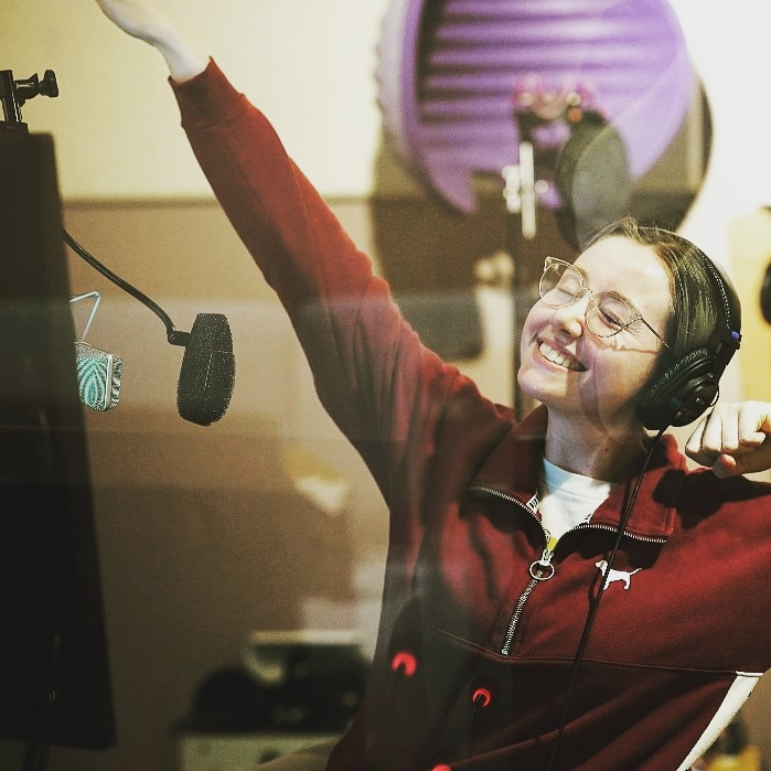 Voice actor Brooke Megan Goodman poses for a photo after recording in a studio. [BROOKE MEGAN GOODMAN]