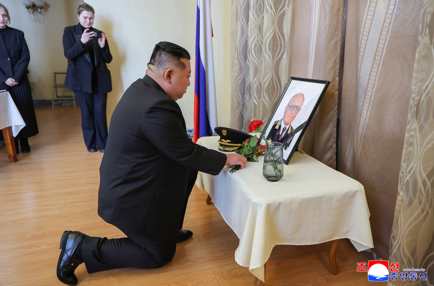 North Korean leader Kim Jong-un offers flowers to the portrait of Russia's Ambassador Aleksandr Matsegora during his condolence visit to the Russian Embassy in Pyongyang on Dec. 10. [YONHAP]