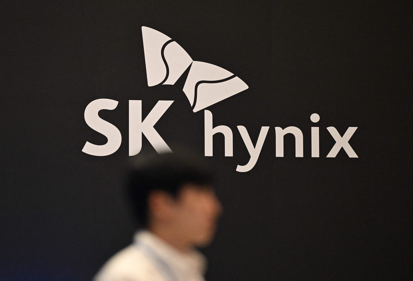 A man walks past SK hynix's logo during a semiconductor exhibition at Coex in Gangnam District, southern Seoul on Oct. 24, 2024. [AFP/YONHAP]