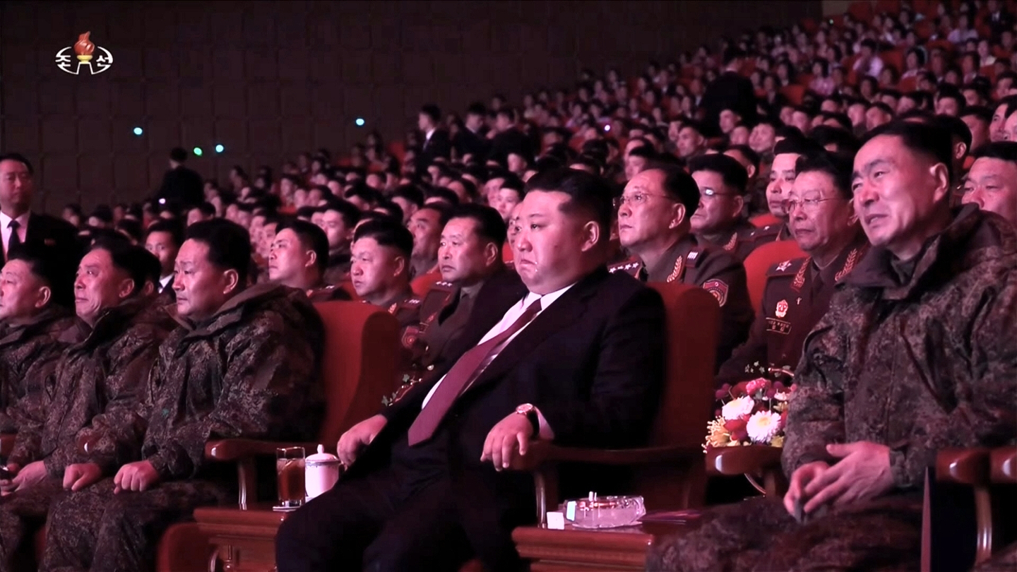 North Korean state television Korean Central Television airs footage on Dec. 13 showing North Korean leader Kim Jong-un shedding tears as photos of fallen soldiers are displayed on stage during a celebratory performance welcoming home members of the 528th Engineering Regiment. [SCREEN CAPTURE]