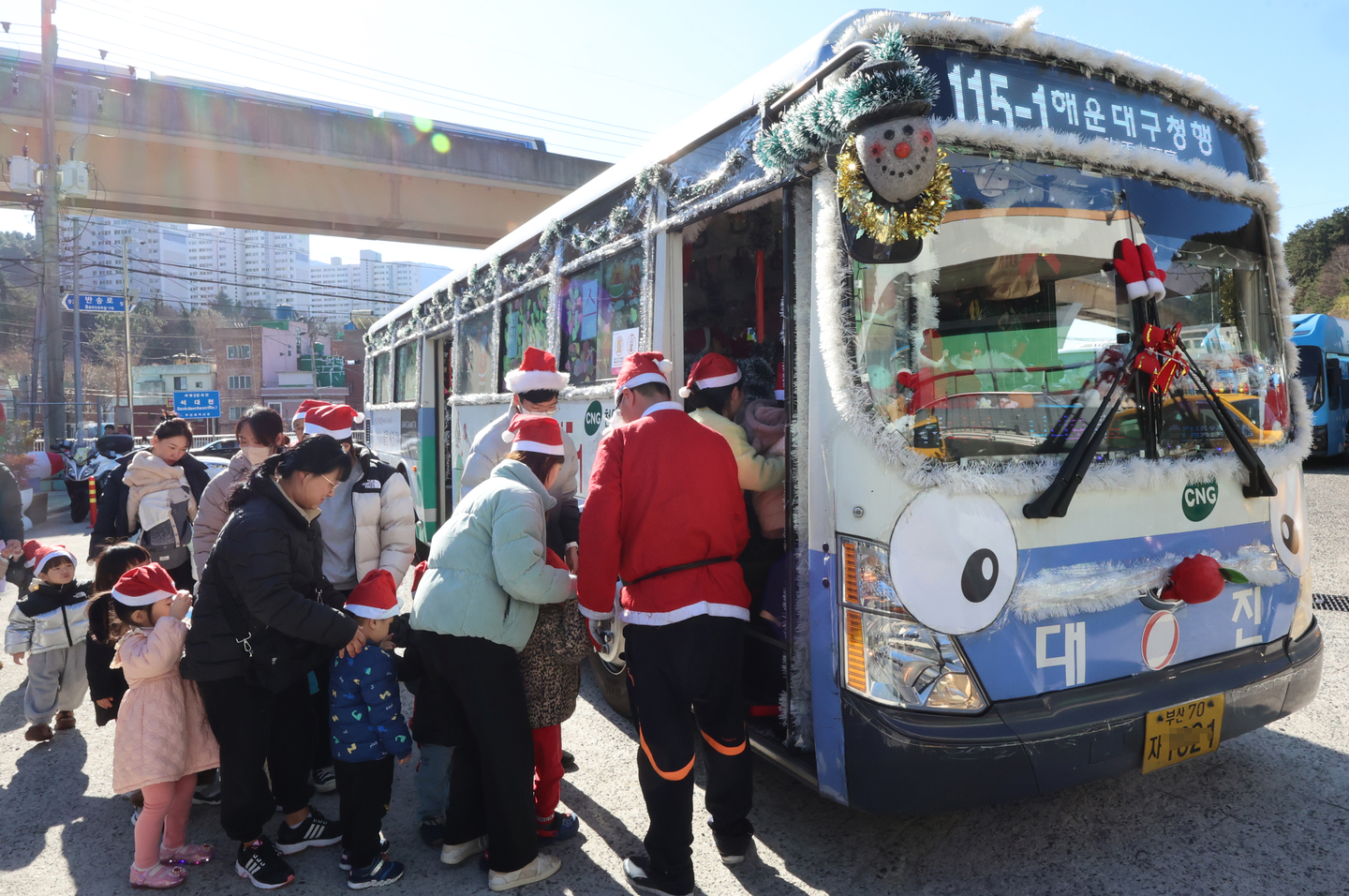 Children visit the Santa Bus in Busan on Dec. 24, 2024. [YONHAP]