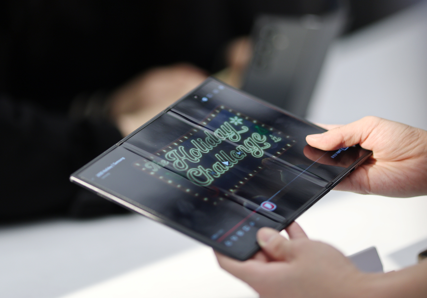 A visitor at the Samsung Gangnam store in Seocho District, southern Seoul holds a Samsung Galaxy Z TriFold smartphone duirng a media day event on Dec. 2. [YONHAP] 