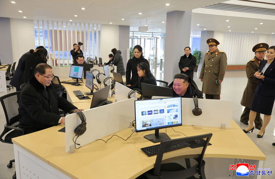 Kim Jong-un, fifth from right, tours newly built facilities in Gangdong County, on the outskirts of Pyongyang, with his daughter Kim Ju-ae, sixth from right, and his wife, Ri Sol-ju, seventh from right, on Dec. 15. [KOREAN CENTRAL NEWS AGENCY]