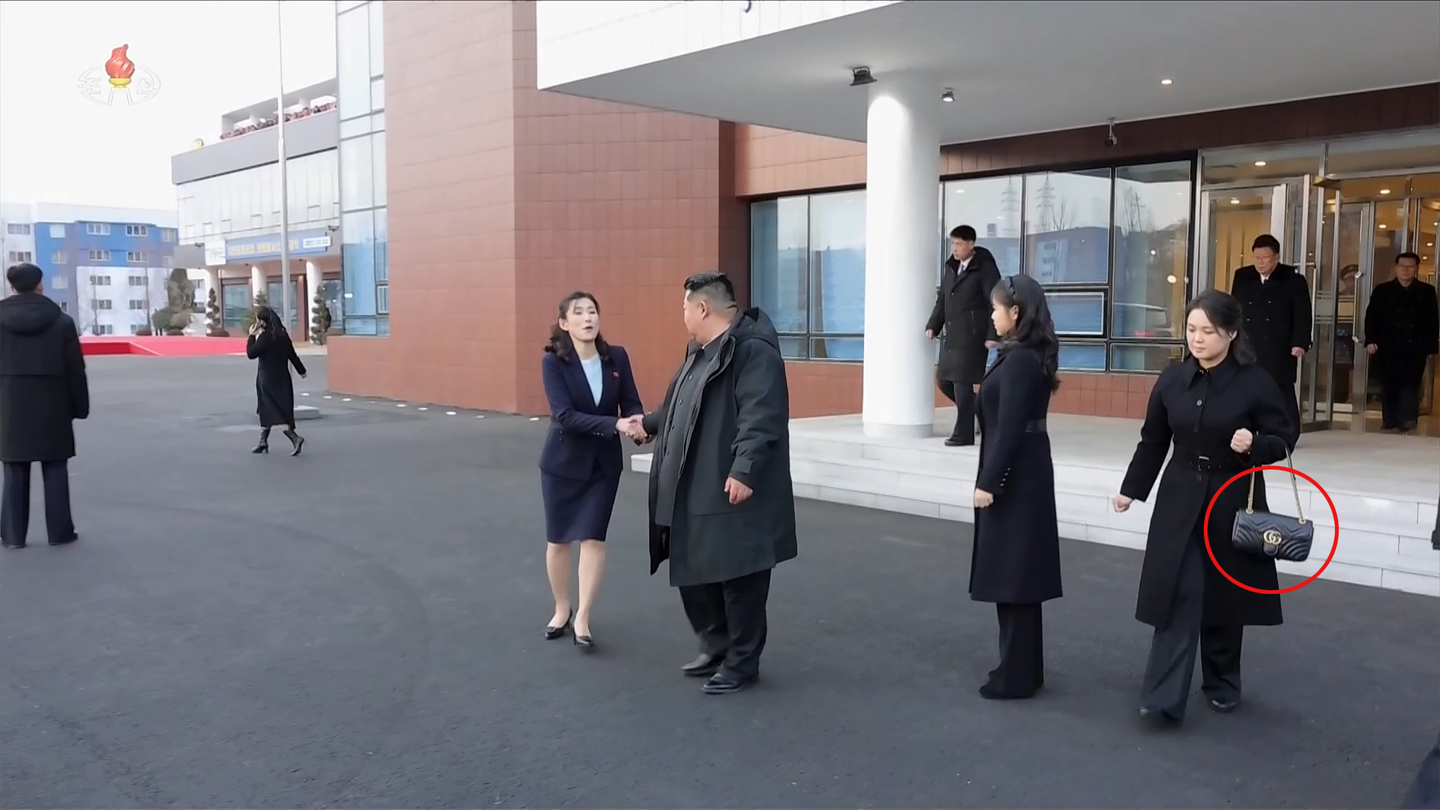 Kim Jong-un, center, tours newly built facilities in Gangdong County, on the outskirts of Pyongyang, with his daughter Kim Ju-ae, second from right, and his wife, Ri Sol-ju, right, on Dec. 15. The red circle shows a Gucci bag that Ri is clutching. [KOREAN CENTRAL NEWS AGENCY]