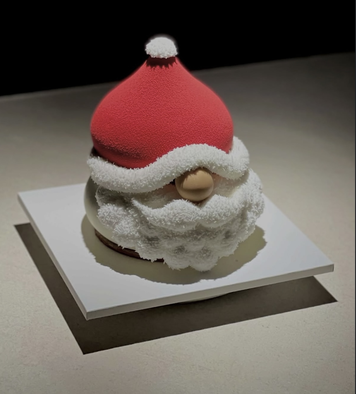 A Santa-shaped cake dusted with coconut powder to resemble freshly fallen snow, by Bakery Souslegui [SCREEN CAPTURE]