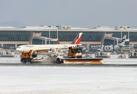 The photo shows a runway at Incheon International Airport. [INCHEON AIRPORT] 
