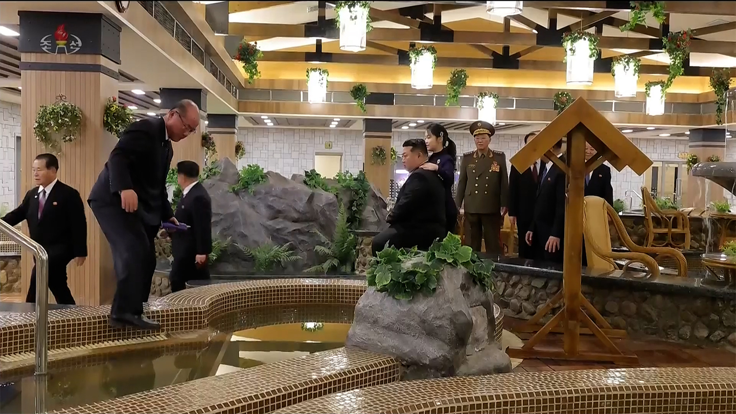 North Korean leader Kim Jong-un, center, tours indoor hot spring facilities with his daughter, Kim Ju-ae, during the completion ceremony of the Milyong Hotel in Samjiyon on Dec. 20. Kim Ju-ae is seen standing with her hand resting on her father’s shoulder. [KOREAN CENTRAL TELEVISION]