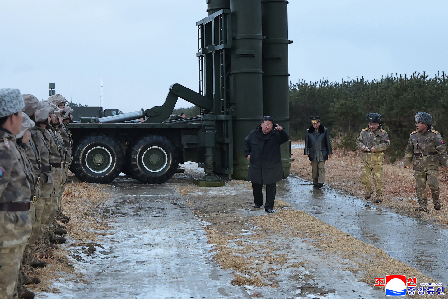 North Korean leader Kim Jong-un, center, is seen observing the launch of a new surface-to-air missile on Dec. 24. [KOREAN CENTRAL NEWS AGENCY]
