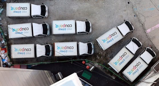 Delivery vehicles sit parked at a Coupang logistics center in Seoul on Dec. 4. [YONHAP]