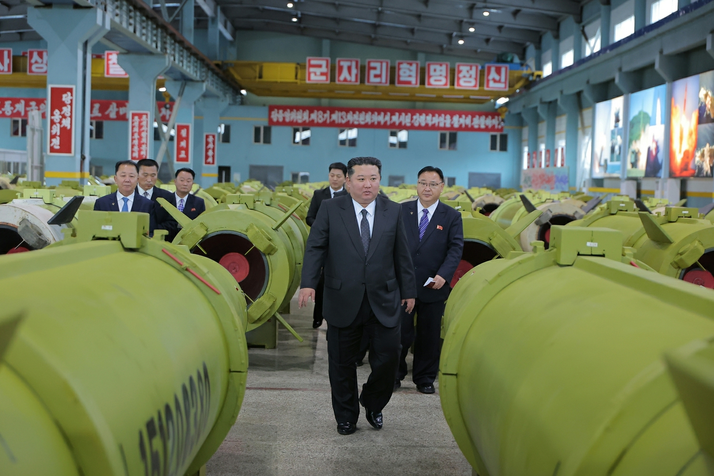 North Korean leader Kim Jong-un, center, inspects major munitions factories while calling for expanding the production of missiles and shells, in this photo carried by the North's official Korean Central News Agency on Dec. 26. [KOREAN CENTRAL NEWS AGENCY]