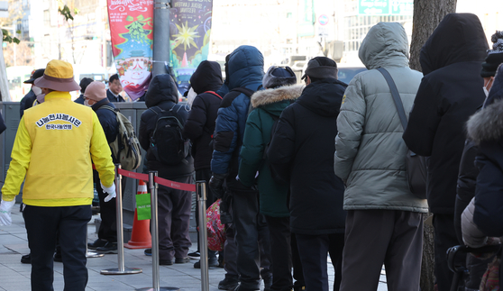 People are seen lined up at a charity center giving out free meals in Jongno District, central Seoul on Dec. 4. [YONHAP] 