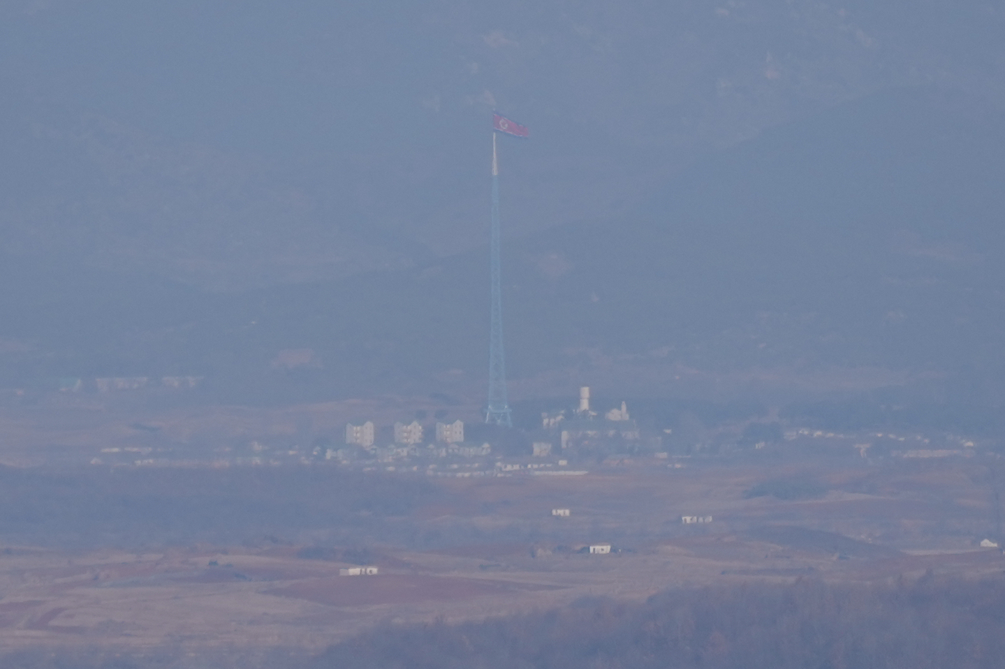 A North Korean flag flutters in the wind atop a 160-meter tower in North Korea's Kijong-dong village, near the truce village of Panmunjom, seen from Paju, Gyeonggi on Dec. 25. [AP/YONHAP] 