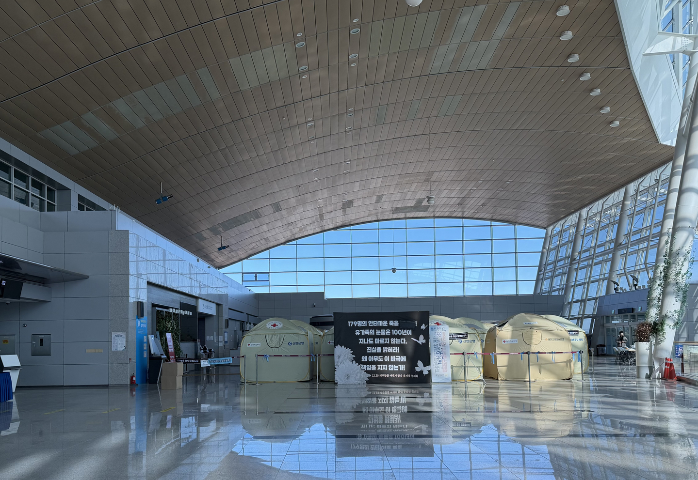 Dozens of yellow emergency tents are installed on a departure floor at Muan International Airport in South Jeolla on Dec. 22. [LEE SOO-JUNG]