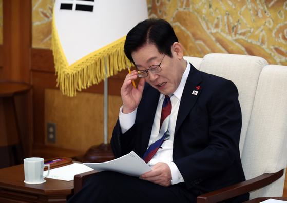 President Lee Jae Myung looks at documents during a meeting at the Blue House in central Seoul on Dec. 29. [NEWS1]
