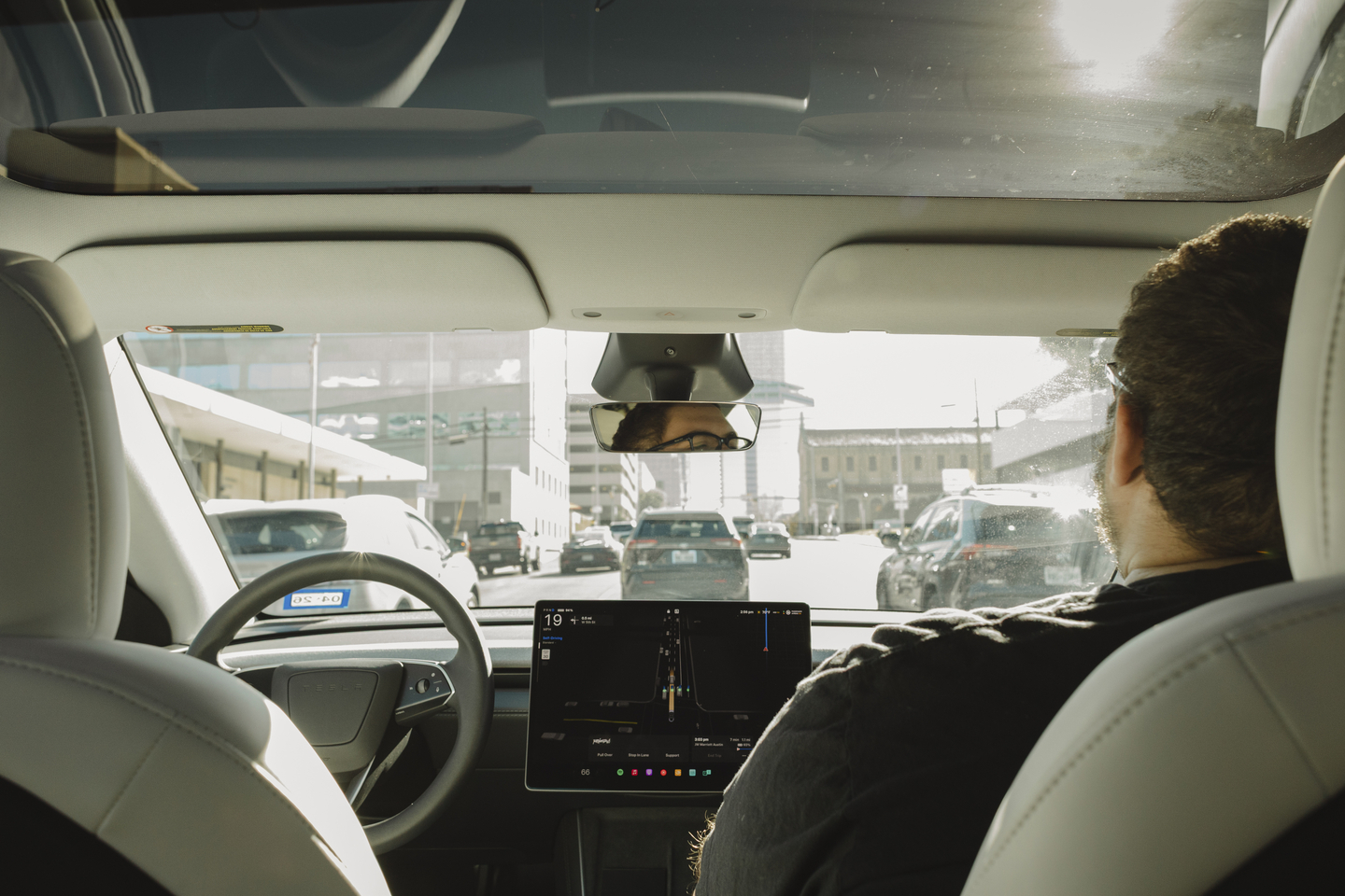A Tesla robotaxi drives with a safety monitor sitting in the passenger seat in Austin, Dec. 9, 2025. Shares of Tesla have hit new highs on optimism about the company’s self-driving taxis. But experts say Tesla is far behind Waymo, which has a big head start. (Ariana Gomez/The New York Times) 