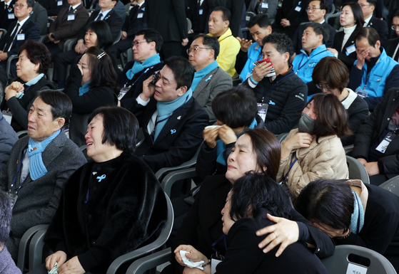 Bereaved families shed tears during a memorial ceremony on Dec. 29 at Muan International Airport in South Jeolla, marking one year since the Jeju Air crash. [YONHAP]