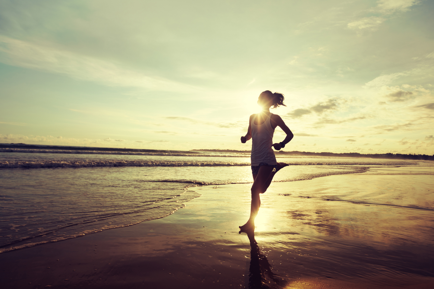 A person runs along a beach at sunnrise. [GETTY IMAGES BANK]
