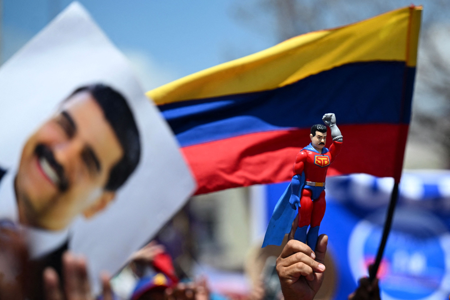 A supporter of Venezuelan President and presidential candidate Nicolas Maduro raises a dummy of the character known as ″Super Bigote,″ which represents Maduro, during his campaign closing rally in Maracaibo, Zulia State, Venezuela on July 25, 2024. [AFP/YONHAP]