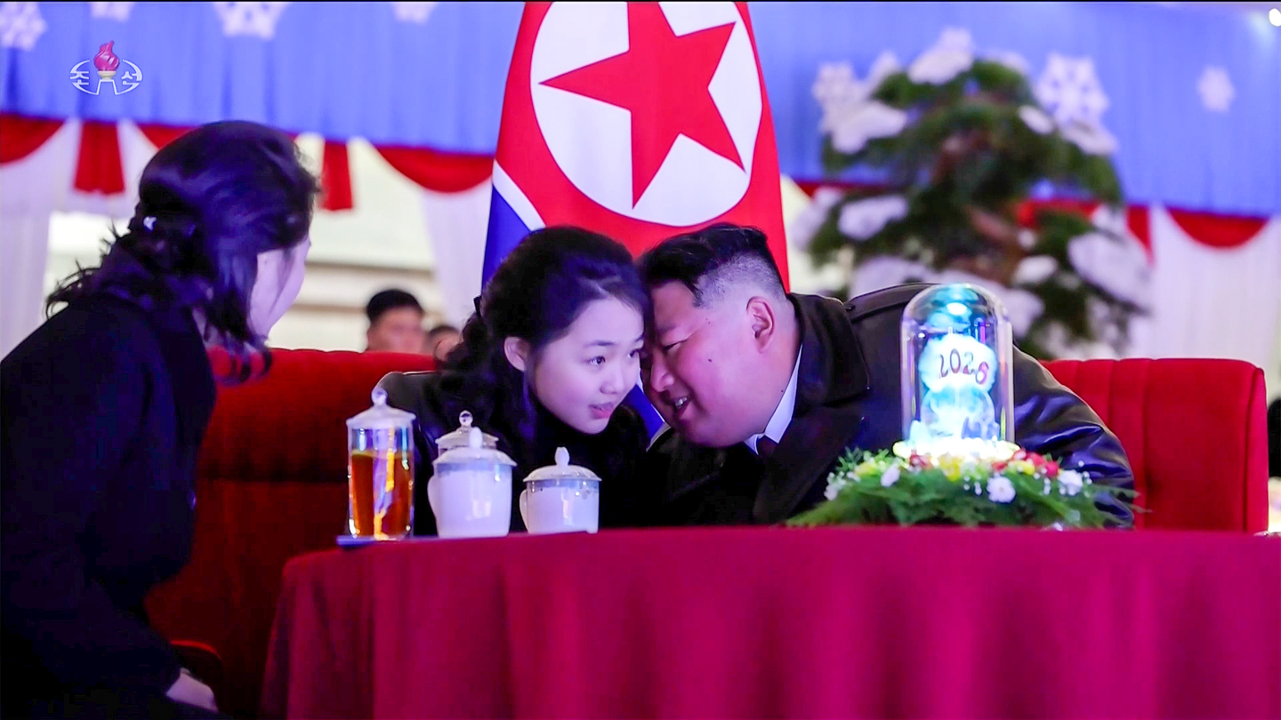 North Korean leader Kim Jong-un whispers to his daughter, Kim Ju-ae, while attending the 2026 New Year’s celebration performance at the May Day Stadium in Pyongyang on Jan. 1. [KOREAN CENTRAL TELEVISION] 