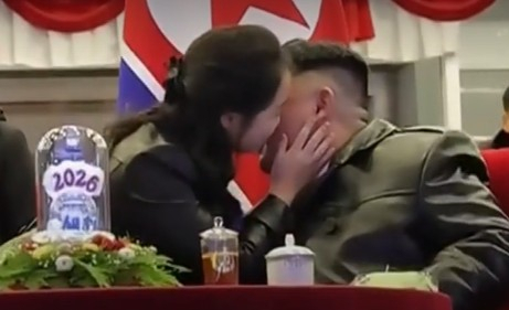 Kim Ju-ae, the daughter of North Korean leader Kim Jong-un, kisses her father on the cheek after the New Year’s countdown ends during the 2026 New Year’s celebration performance at the May Day Stadium in Pyongyang on Jan. 1. [KOREAN CENTRAL TELEVISION] 