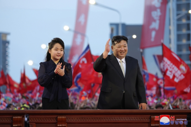 North Korean leader Kim Jong-un, right, greets residents with his daughter Kim Ju-ae, left, at a completion ceremony for Jonwi Street in northern Pyongyang in May 2024. [KOREAN CENTRAL NEWS AGENCY] 