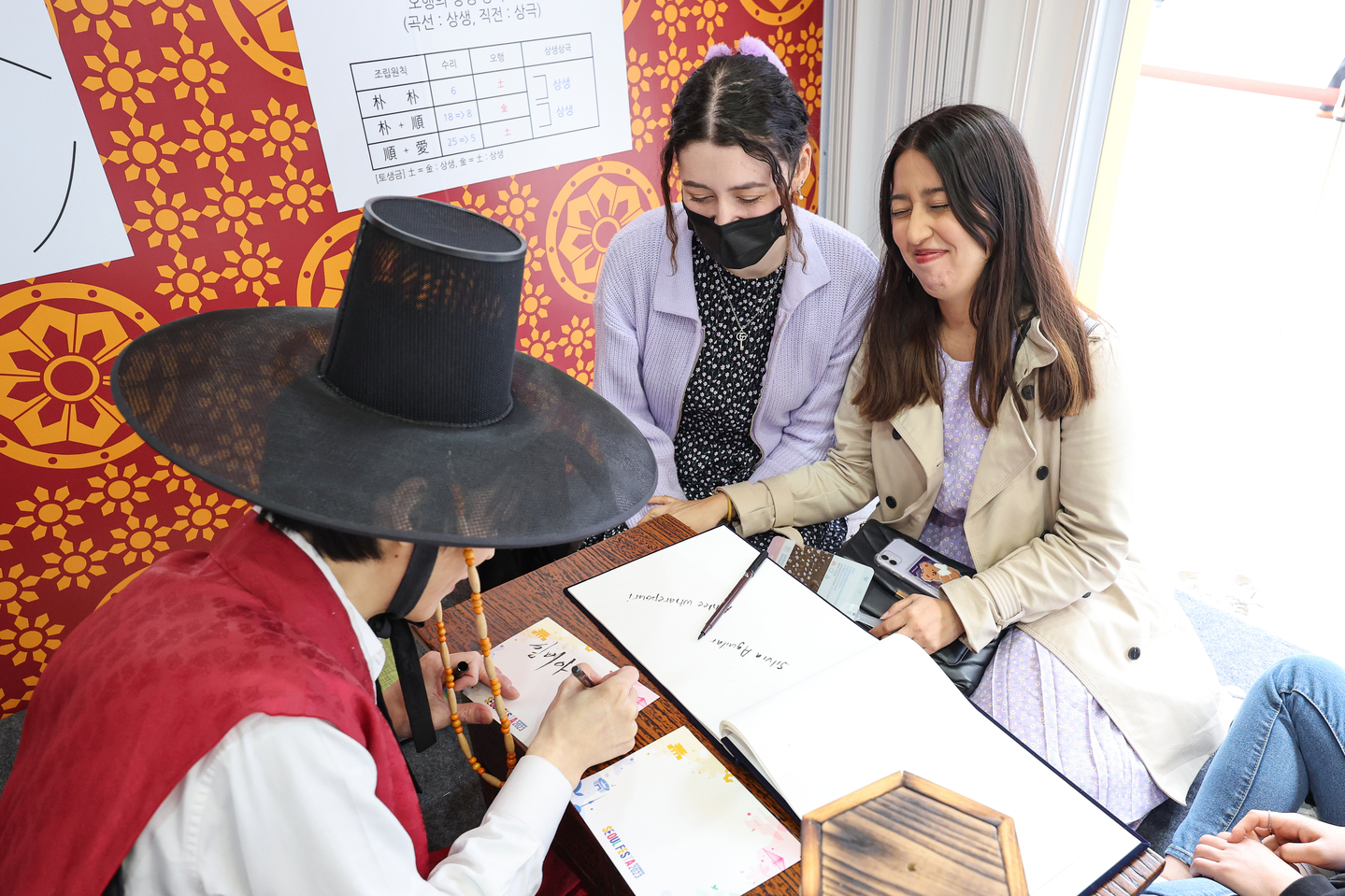 Foreigners try getting a Korean name based on saju during the Seoul Festa 2023 event on April 30, 2023. [YONHAP]