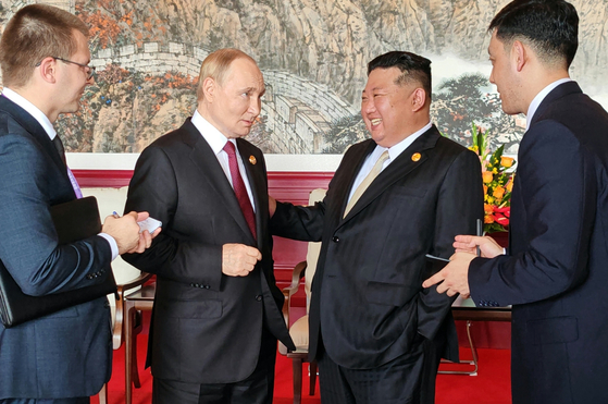 North Korean leader Kim Jong-un, right, talks with Russian President Vladimir Putin during a meeting in Beijing on Sept. 3, 2025, as part of China's Victory Day celebrations. The picture was distributed by Rodong Sinmun on Sept. 4, 2025. [RODONG SINMUN]
