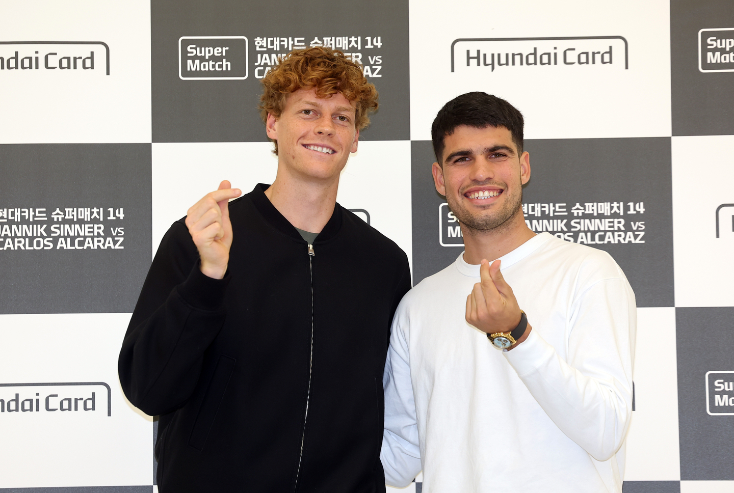 Jannik Sinner of Italy, left, and Carlos Alcaraz of Spain pose for photos after their press conference in Seoul on Jan. 9, on the eve of their exhibition tennis match in Korea. [YONHAP]