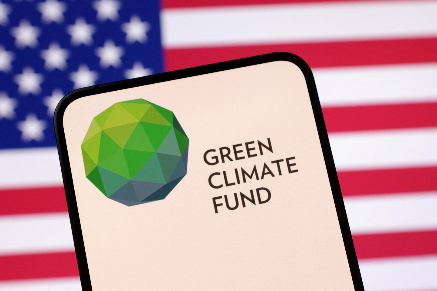 Green Climate Fund logo and the U.S. flag are seen in this illustration taken on April 23, 2025. [REUTERS/YONHAP]