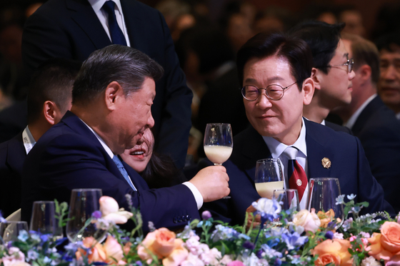 President Lee Jae Myung, right, toasts with Chinese President Xi Jinping at the welcome dinner of the APEC gathering in Gyeongju, North Gyeongsang, on Oct. 31.