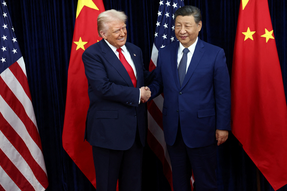 U.S. President Donald Trump, left, greets Chinese President Xi Jinping as they hold a bilateral meeting at Gimhae International Airport, on the sidelines of the Asia-Pacific Economic Cooperation (APEC) summit, in Busan on Oct. 30.  [REUTERS/YONHAP]