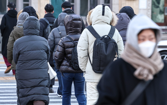 Commuters hurry to work at the Gwanghwamun intersection in Jongno District, central Seoul on Jan. 8. [NEWS1]