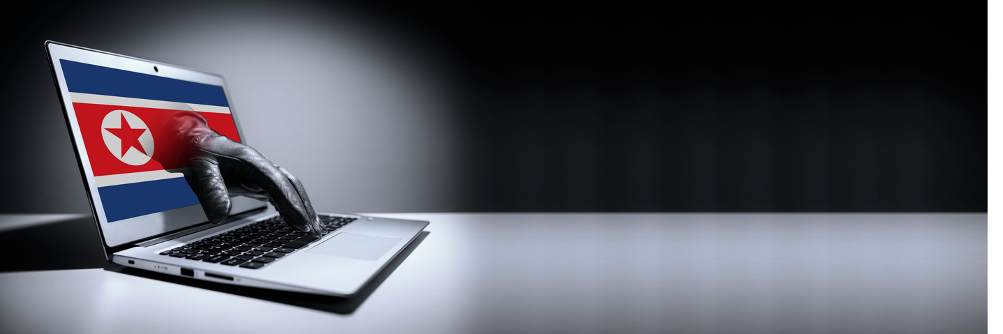 The North Korean flag and a laptop are seen in this file image. [JOONGANG ILBO]