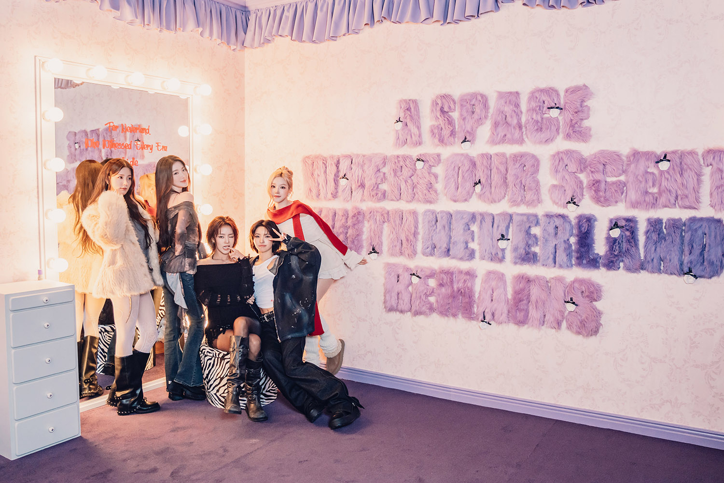 i-dle members pose for a photo in front of a media exhibition on the girl group, titled ″City of Sense,″ in eastern Seoul. The exhibition will open in Shenzhen, China, and Taipei, Taiwan. [CUBE ENTERTAINMENT]